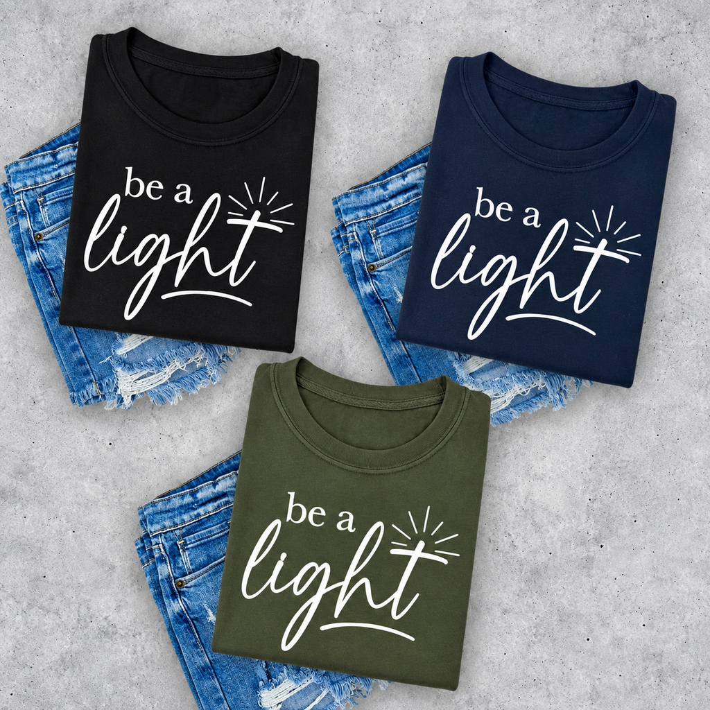 Be A Light logo fundraiser tee in black, navy, and military green