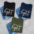 Be A Light logo fundraiser tee in black, navy, and military green